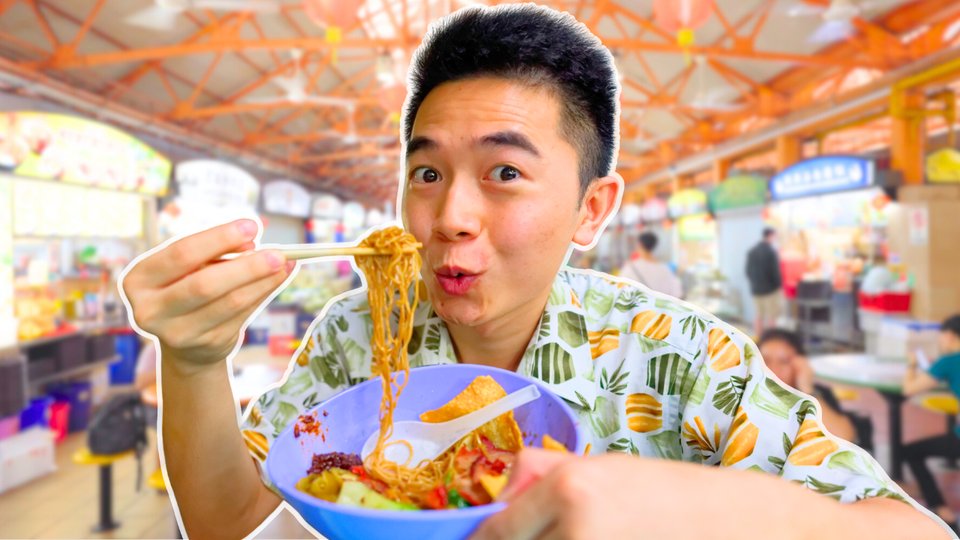 Tomy digging into a hawker centre bowl